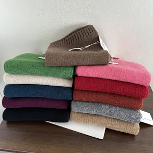 Detailed view of colorful knitted wool scarves for autumn and winter, warm and soft texture.