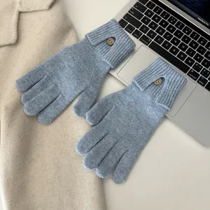 Stylish knit touchscreen gloves with single button detail for warm autumn and winter wear.