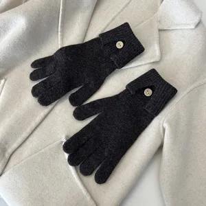Knit gloves detail view, winter touch screen compatible warm gloves with single button accent.