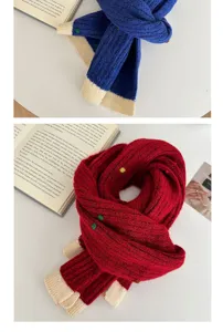 Detailed view of winter knitted scarf with ribbed texture and color block ends for cold days.