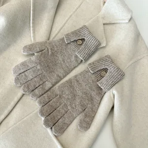 Knit touchscreen gloves detail shot, cozy oatmeal winter gloves with button cuff design.