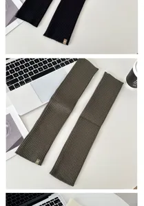 Ribbed knit leg warmers detail view, cozy winter long sock covers displayed on white desk.