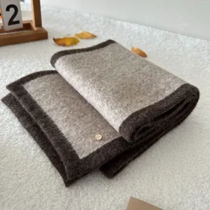 Cozy wool-blend color-block scarf with elegant contrast border for warm winter days.