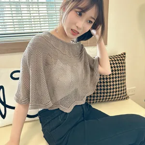 Details of the women's hollow knitted short sleeve poncho shawl for spring and summer comfort.