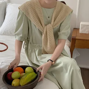 Close-up detail shot of knitted hollow small shawl and dress set, elegant daily wear style.