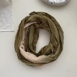 Detail view of the soft cotton linen gradient scarf, showing pleated texture and fabric quality.