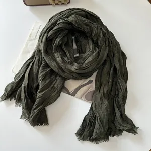 Dark green crinkled cotton linen scarf detail, featuring vintage grid pattern and soft texture.