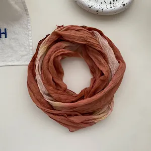 Close-up view of the gradient tie-dye linen cotton scarf with soft wrinkles and folds.