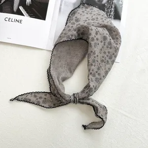 Closeup of Japanese vintage floral cotton linen triangle scarf with delicate lace edge detail.