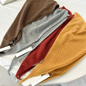 Detailed view of the hollow knitted wool triangle scarf, showing the fine texture and soft fabric.