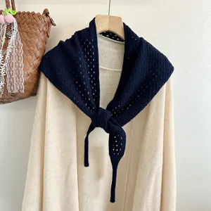 Detailed shot of dark blue hollow knitted wool triangle scarf shawl, Japanese Korean style.