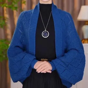 Blue knit cardigan detail shot, diamond pattern, stylish women's sweater shawl outerwear.