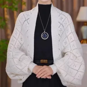 Detailed view of white hollow knit cardigan, diamond pattern, elegant autumn apparel style.