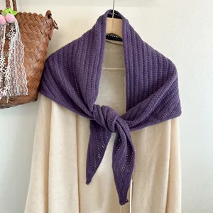 Detail shot of the cozy purple wool triangular knit scarf, highlighting its fine texture.
