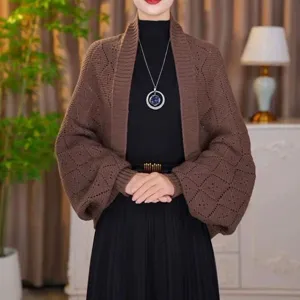 Detailed view of the women's brown knit cardigan featuring geometric diamond pattern.