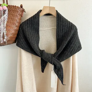 Detailed view of the dark grey wool knit triangle shawl, cozy texture and fine craftsmanship.