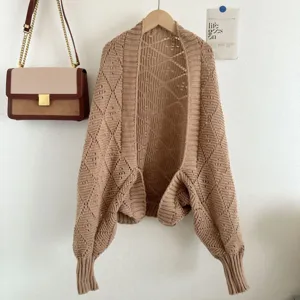 Detailed view of the camel knit open-front cardigan with diamond hollow-out pattern.