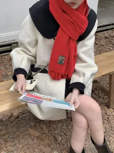 Solid red winter scarf for women, warm plush cashmere feel, classic fringed hem detail.