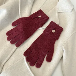 Detailed view of dark red knitted winter gloves with single button cuff design, cozy touch.