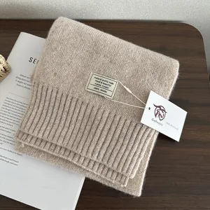 Detail shot of a solid color knitted 100% pure wool winter warm scarf folded neatly.