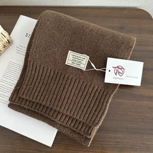 Brown 100% wool knitted scarf detail view, winter warm solid color neckwear fashion.