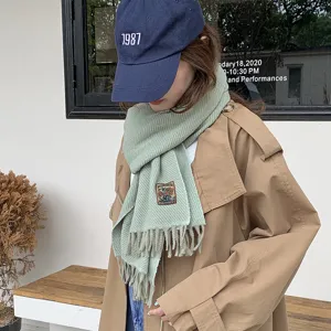 Korean style solid color knitted scarf with fringe for women, warm winter accessory, light green.