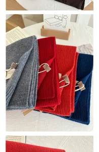 Detailed view of knitted wool cashmere blend scarf, showing soft texture and folded colors.
