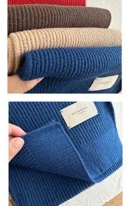 Close up view of soft ribbed knit wool scarf texture detail showing premium quality.