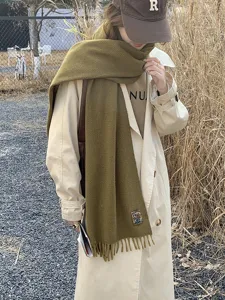 Classic solid color winter warm fringe scarf for women and men, stylish autumn apparel.