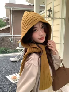 Detailed shot of a stylish mustard yellow knitted hooded scarf for women, warm winter balaclava.