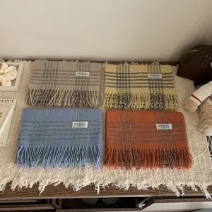 Detailed view of classic wool fringe plaid scarf, autumn winter warm neckerchief style.