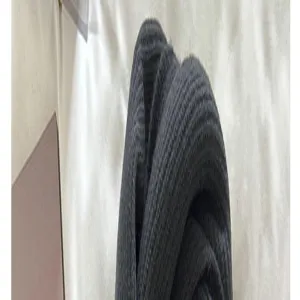 Detailed shot of dark gray knitted wool scarf, showing fine texture and soft fabric.