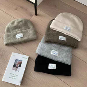 Winter warm wool knit beanie hat for women, stylish slouchy pull-on cap with chic woven label.