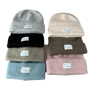 Women's warm wool knit beanie hat casual slouchy winter cap with stylish cloth patch design.