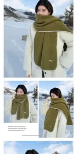 Cozy green wool-blend winter scarf with elegant white lock stitch detail and warm feel.