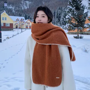 Cozy winter caramel brown wool blend scarf with chic white blanket stitch edges for women.