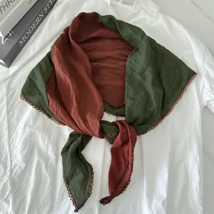 Detailed view of the color-blocked cotton-linen triangle scarf with delicate crochet lace edging.
