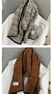 Floral pleated scarf detail view showing beige and brown fabric texture and elegant design.