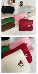 Close-up of cute puppy embroidered knitted scarf with soft texture and vibrant colors.