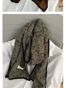 Detail view of the elegant autumn winter floral cotton linen scarf with chic black trim design.