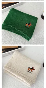Close-up view of cute puppy embroidered knitted scarf detail texture winter warm neck accessory.