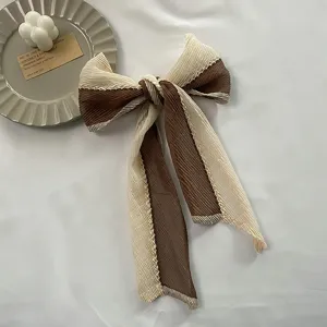 Elegant pleated bow hair scarf ribbon, brown and cream colorblock hair accessory for women.