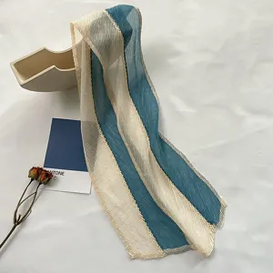 Close-up detail of pleated blue and white striped hair ribbon scarf, elegant styling prop.