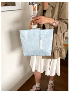 Elegante chinesische Stoff-Tragetasche mit Bambusgriff und Quaste, großes Fassungsvermögen.