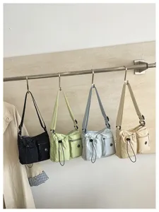 Lightweight nylon multi-functional casual shoulder crossbody bag with multiple pockets.