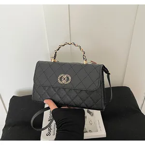 Detailed view of black quilted PU leather shoulder bag with metal chain handle and chic clasp.