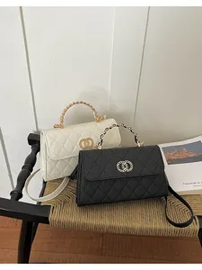 Close-up detail view of elegant quilted chain shoulder bags in black and white colors.