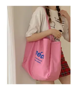 Pink canvas tote bag for women, large capacity casual shoulder bag for daily shopping use.