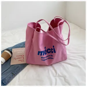 Pink canvas tote bag for women, casual large capacity shopper bag with blue letter print detail.