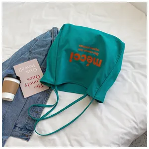 Green canvas tote bag with orange graphic print, casual large capacity shopping bag detail.